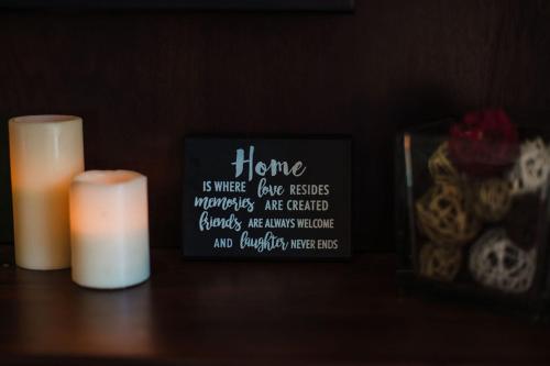 a candle and a sign on a table with skulls at Platinum Cawa Apartments in Nadi