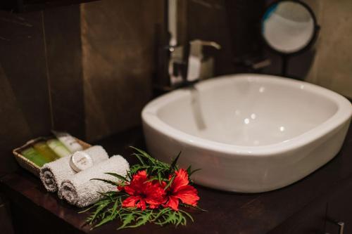 a bathroom with a sink and a bath tub at Platinum Cawa Apartments in Nadi