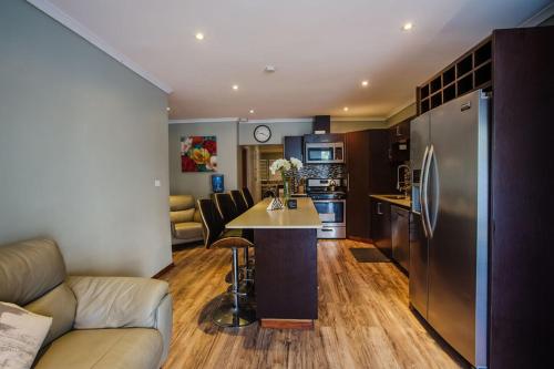 a kitchen and living room with a couch and a refrigerator at Platinum Cawa Apartments in Nadi