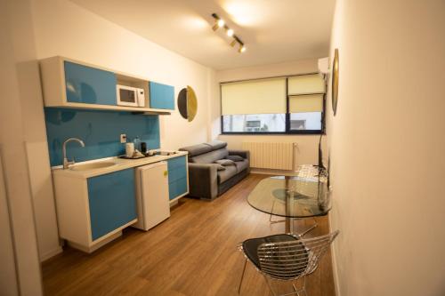 a kitchen and living room with a sink and a table at Iassium Residence Iasi in Iaşi