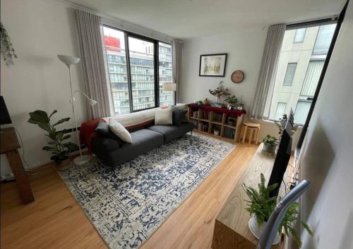 a living room with a couch and a rug at South Melbourne Central 1BR - 106 in Melbourne