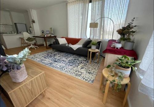 a living room with a couch and a table at South Melbourne Central 1BR - 106 in Melbourne