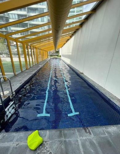 a swimming pool with blue tiles in a building at South Melbourne Central 1BR - 106 in Melbourne