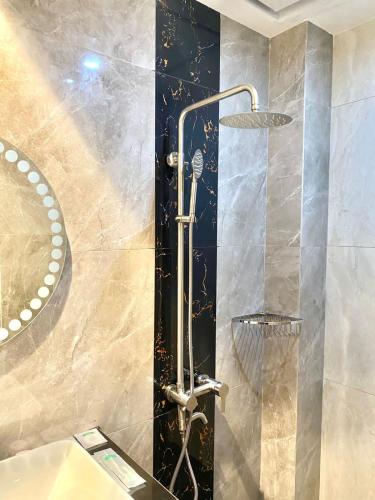 a bathroom with a shower with a shower head at Petro Inn Takengon in Takengon