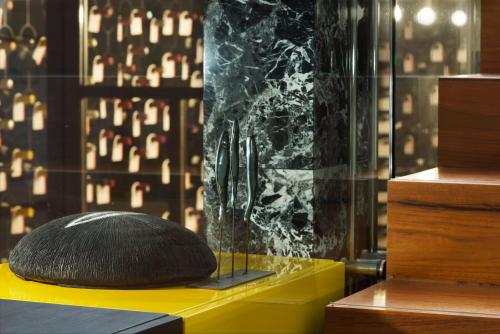 a black pillow sitting on top of a yellow table at Magic Forte in Forte dei Marmi