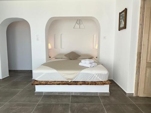 a bedroom with a bed in a white room at Charakas Horizon in Gavrion