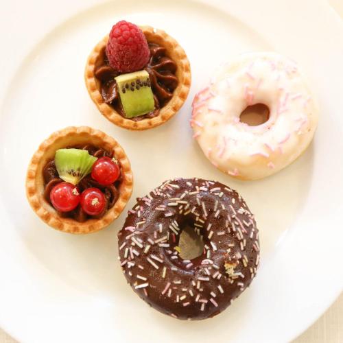 a white plate with four donuts and a waffle at Hotel Polo in Rimini