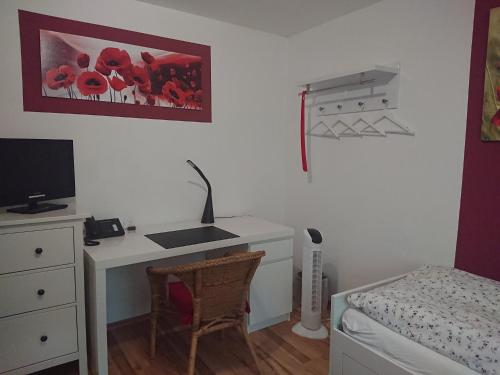 a bedroom with a desk and a bed with a computer at Landgasthof Gänsberg in Wiesloch