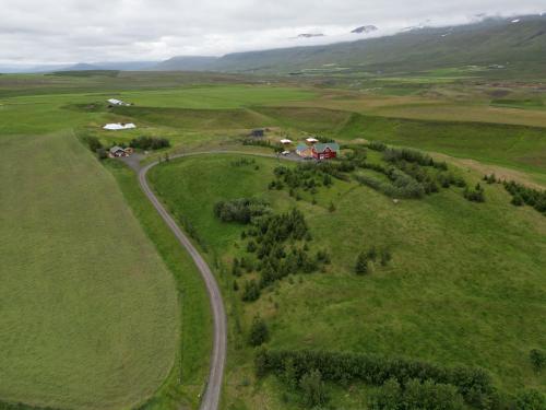 an aerial view of a farm in a green field at Armuli in Reynistaður