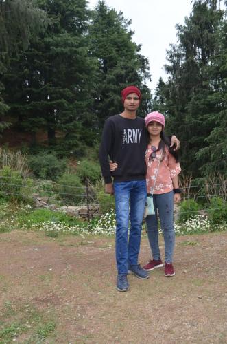 a man and a woman standing in a field at Hari Om Paradise in Kūfrī
