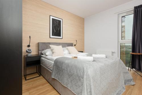 Posteľ alebo postele v izbe v ubytovaní Sucha 39 Apartments Nowa Letnica by Renters