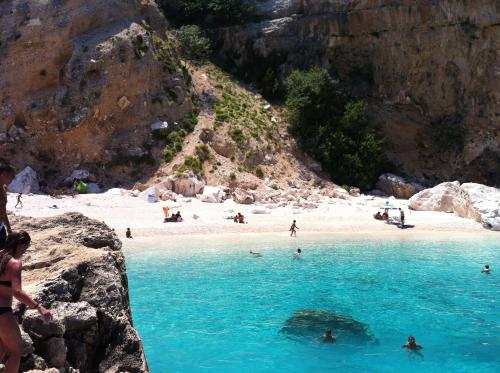 a group of people in the water at a beach at CASE ORCHIDEA - ROSA BLU in La Caletta
