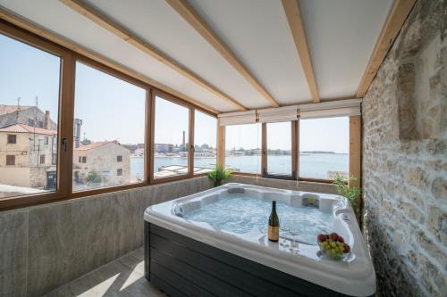 a bath tub in a room with windows at Luxury Villa Christian in Umag