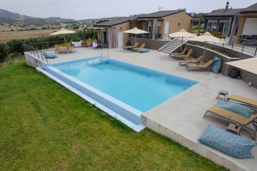 an overhead view of a swimming pool with chairs and umbrellas at Kamino in Kalandra