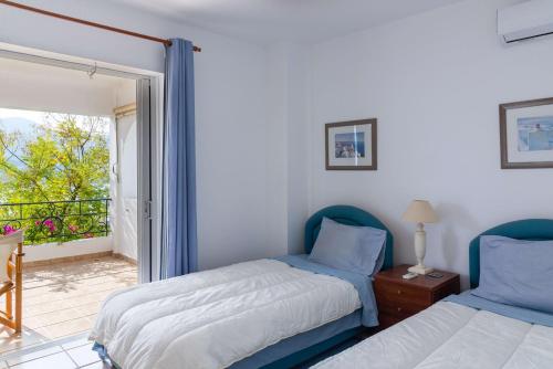 a bedroom with two beds and a balcony at Porto sea view house - 15min from Athens airport - AC - WIFI - PARKING in Porto Rafti