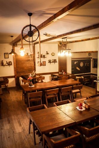 a dining room with wooden tables and chairs at Green Garden Plitvice lakes in Plitvica selo