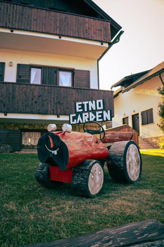 a sculpture of a car on the grass in front of a house at Green Garden Plitvice lakes in Plitvica selo