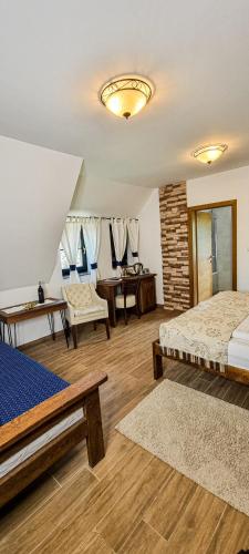 a bedroom with two beds and a table and chairs at Green Garden Plitvice lakes in Plitvica selo
