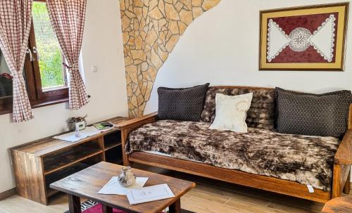 a living room with a couch and a table at Green Garden Plitvice lakes in Plitvica selo