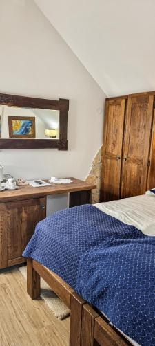 a bedroom with a bed and a desk and a mirror at Green Garden Plitvice lakes in Plitvica selo