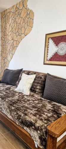 a bed in a room with a couch and a table at Green Garden Plitvice lakes in Plitvica selo
