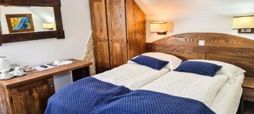 a bedroom with a bed with blue and white pillows at Green Garden Plitvice lakes in Plitvica selo