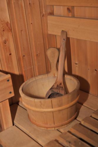 a wooden spoon sitting in a bucket in a room at Ardlui Lochside Lodges in Ardlui
