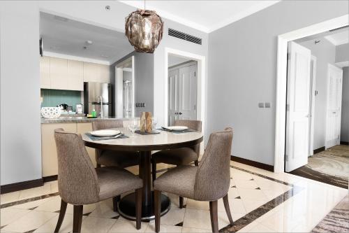 a dining room with a table and chairs at Ascott Makati in Manila