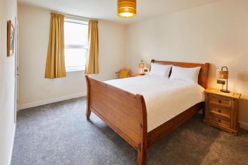 a bedroom with a large bed and a window at Ground Floor at the Old Vicarage in Scarborough