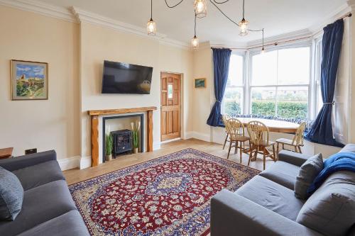a living room with a couch and a table at Ground Floor at the Old Vicarage in Scarborough