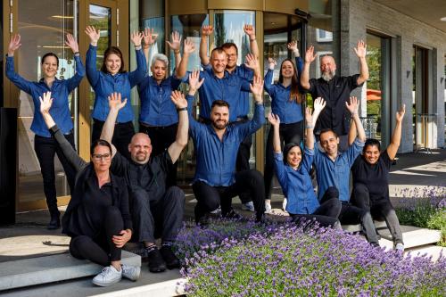 a group of people with their hands in the air at Hotel Allegra Lodge in Kloten