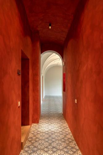 a hallway with red walls and an archway at Villa Unterswand - Self Check-in in Grünau im Almtal