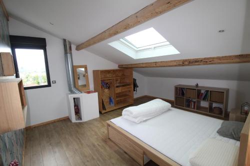 a bedroom with a large bed and a skylight at OXTER BAÏTA AVEC LES CLES DE SAINT JEAN DE LUz in Ciboure