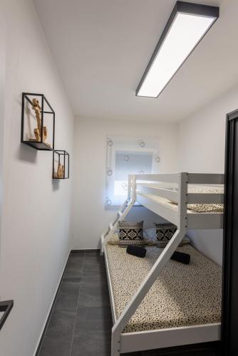a bedroom with a bunk bed in a room at Apartment Lo&Ti in Čižići