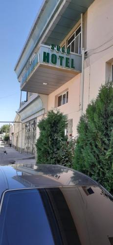 a car parked in front of a hotel at Hotel SUGD & Guest House in Panjakent