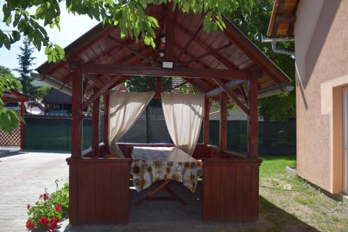 a wooden gazebo with a table in it at Gamma in Praid