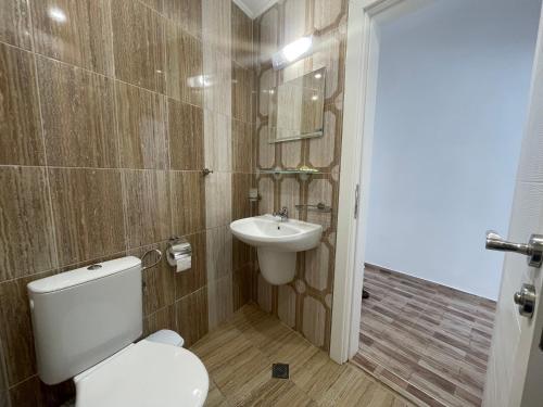 a bathroom with a toilet and a sink at Cozy Elegant Room in Perla Del Mar complex in Lozenets