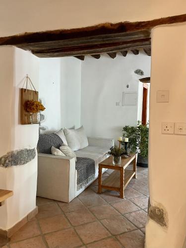 a living room with a couch and a table at Stone built country house in Louvaras Village in Louvaras