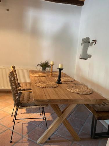 a wooden table with two candles on top of it at Stone built country house in Louvaras Village in Louvaras