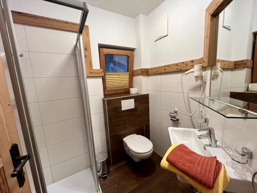 a bathroom with a toilet and a sink at Kama Alm in Aschau