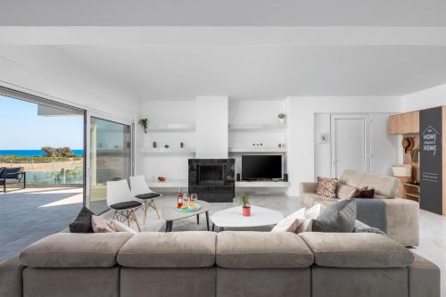 a living room with a couch and a table at Viviane Paulos Villa in Gennadi