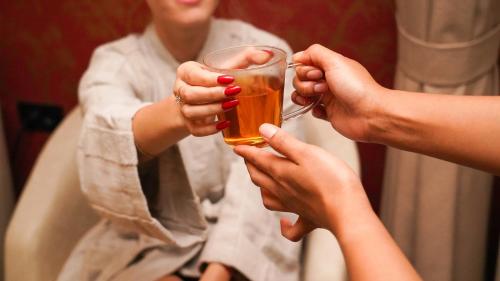 two people holding a glass of beer in their hands at Cronton Design Hotel in Istanbul