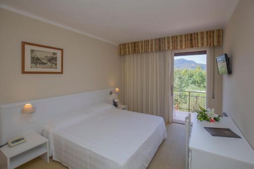 Postel nebo postele na pokoji v ubytování Hotel Fabricia