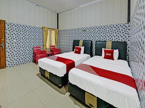 En eller flere senger på et rom på SPOT ON 91376 Hotel Bintang Flores