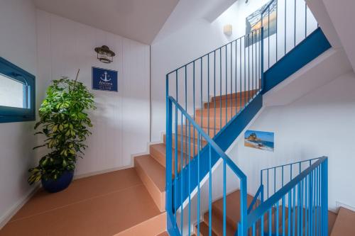 a blue staircase in a room with a plant at Áncora Salou La Siesta Apartments in Salou