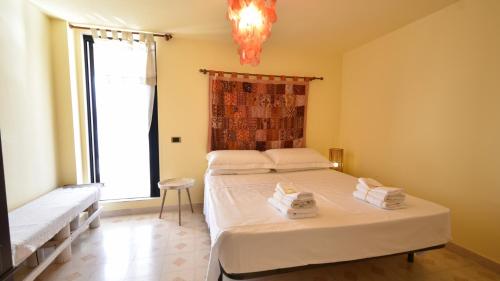 a bedroom with two beds and a large window at Les Maisons La Mansardina by Rentbeat in Sannicola