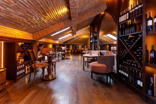 a wine tasting room with tables and chairs and wine bottles at Cronton Design Hotel in Istanbul