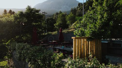 a train on a track with a mountain in the background at Rouista Tzoumerka Resort in Vourgareli