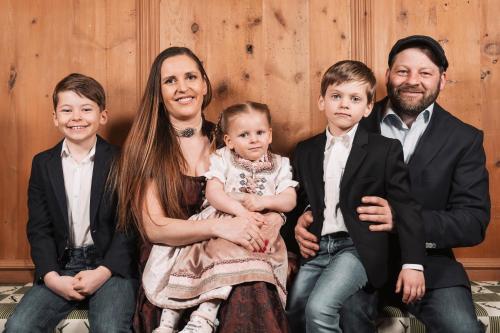a family posing for a picture together at Hotel Piz Buin in Ischgl