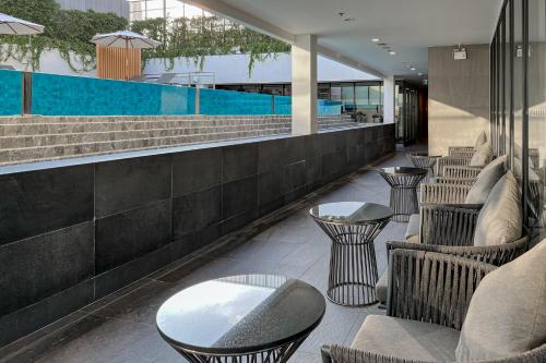 a restaurant with chairs and tables and a pool at Amanta Hotel & Residence Sathorn in Bangkok